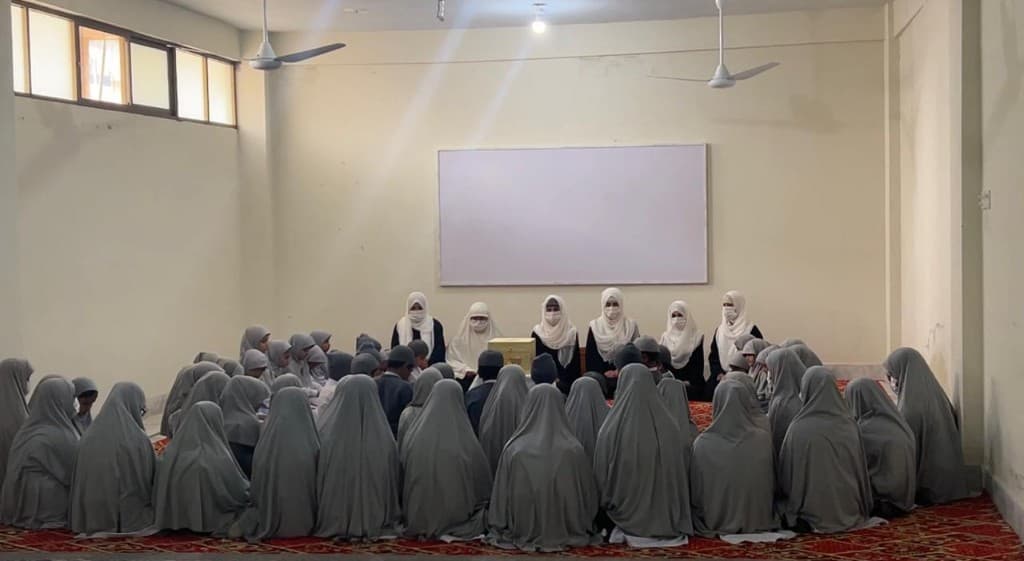 A student gathering during a learning moment at Mahmoodia Foundation.